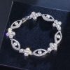 Round Diamonds Cross with Evil Eyes Bracelet in White Gold